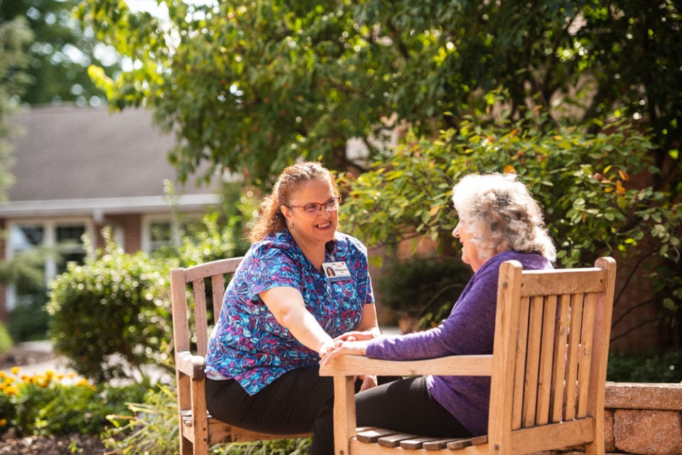 Landis homes employee and resident talking outdoors