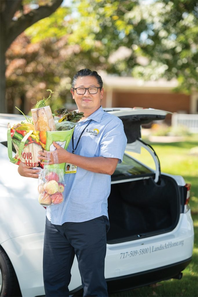 Employee holding groceries portrait