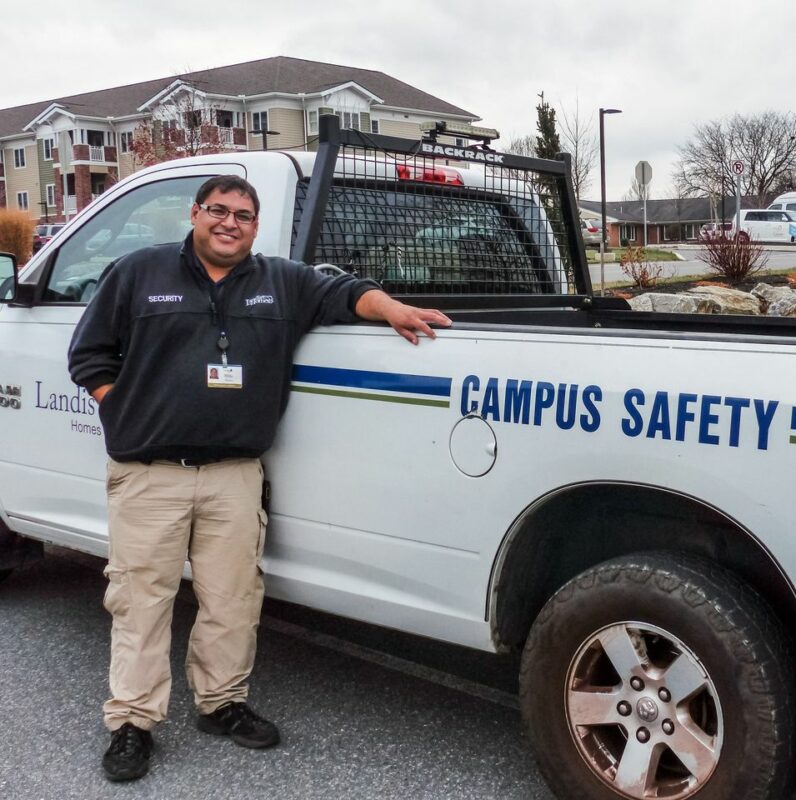 Landis Homes security guard standing by truck.